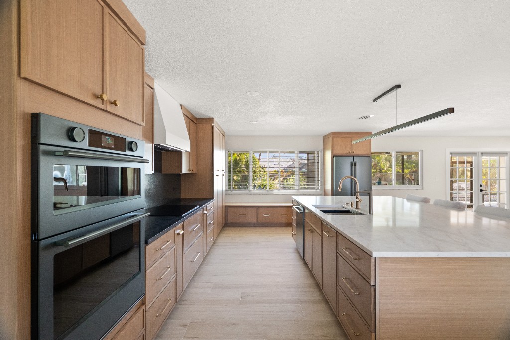 Beautifully renovated kitchen with custom cabinetry and marble island